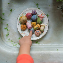 Load image into Gallery viewer, Colorful pastries on a plate with a hand pointing at one, placed on a marble countertop.