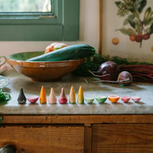 Load image into Gallery viewer, Kitchen counter with vegetables and a row of small colorful pots on a wooden cabinet.