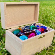 Load image into Gallery viewer, Wooden box filled with colorful gemstones on grass