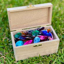Load image into Gallery viewer, Wooden box filled with colorful gemstones on grass