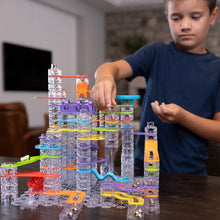 Load image into Gallery viewer, Child playing with a marble run toy set in a living room.
