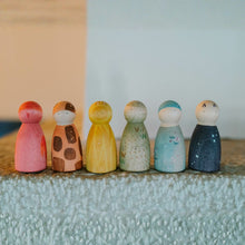 Load image into Gallery viewer, Set of colorful wooden peg dolls on a textured surface with a neutral background