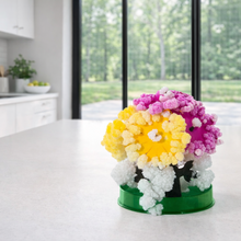 Load image into Gallery viewer, Colorful flower arrangement on a kitchen counter with a view of greenery outside.