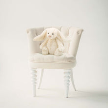 Load image into Gallery viewer, White plush bunny toy on a white chair against a white background