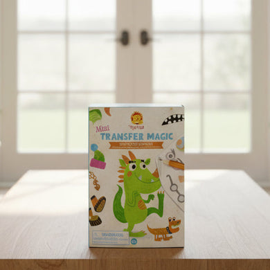 Children's book with a dragon illustration on a wooden table in a bright living room.