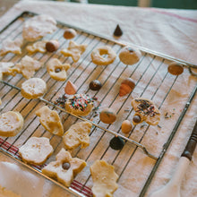 Load image into Gallery viewer, Decorative cookies on a cooling rack with a flour-dusted surface
