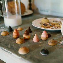 Load image into Gallery viewer, Colorful miniature pastries on a stone surface with a cup of milk and a bowl of sprinkles.
