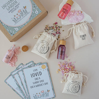 Enchanted Garden magic potion kit with bottles, cards, and drawstring bags on a light background