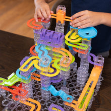 Load image into Gallery viewer, Colorful marble run toy set with clear base on a wooden surface
