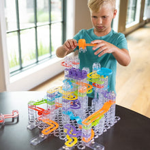 Load image into Gallery viewer, Child playing with a colorful marble run toy set indoors.
