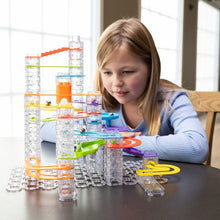 Load image into Gallery viewer, Child playing with a marble run toy set on a table.
