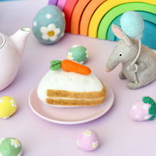 Load image into Gallery viewer, Pastel-colored Easter-themed cake with a carrot decoration, surrounded by decorative eggs and a toy squirrel on a light purple background.
