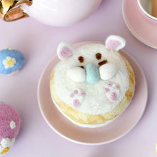 Load image into Gallery viewer, Donut with bunny face decoration on a pink plate with tea set in the background
