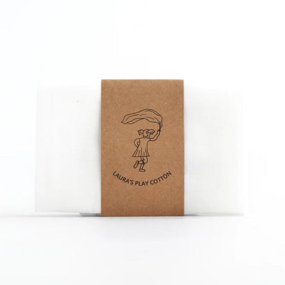 Kraft paper packaging with a printed design and white cotton fabric, on a white background