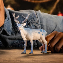 Load image into Gallery viewer, White deer figurine with blue spots on a wooden surface
