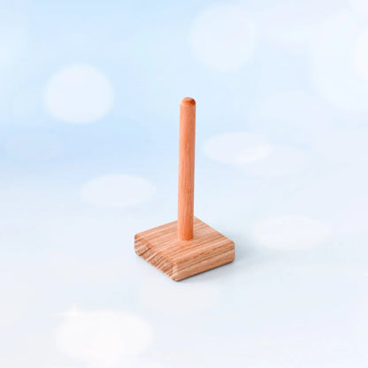Wooden paper towel holder on a light blue background