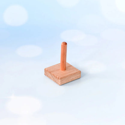 Wooden stand with a cylindrical object on a light blue background