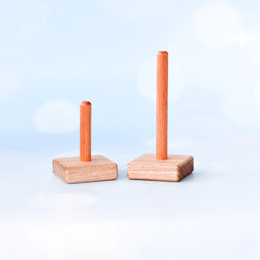 Two wooden stand-up items with vertical sticks on a light blue background