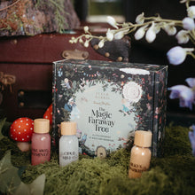 Load image into Gallery viewer, A decorative product box labeled 'The Magic Faraway Tree' sits on green moss with small bottles and mushrooms around it in a styled natural setting.
