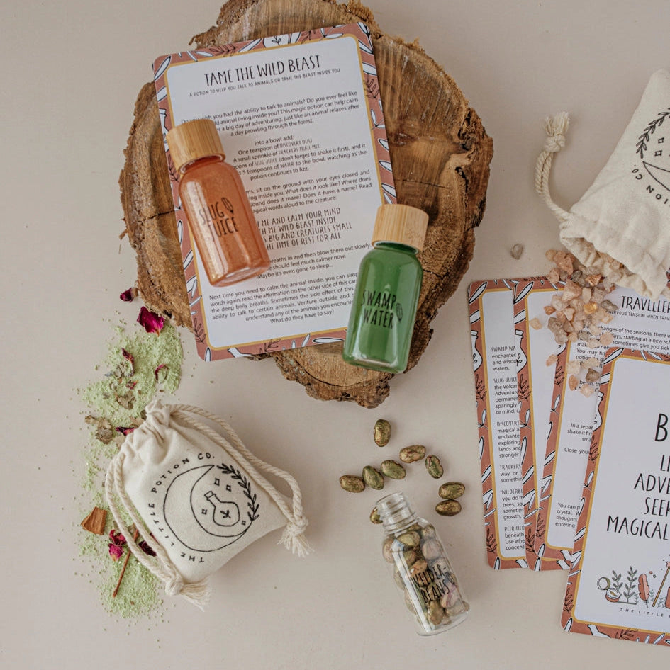 Collection of natural products including bottles, a soap bar, and packaging on a wooden surface.