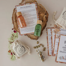 Load image into Gallery viewer, Collection of natural products including bottles, a soap bar, and packaging on a wooden surface.
