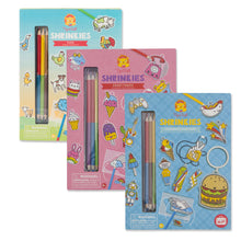 Load image into Gallery viewer, Packaging of Shrinkies craft kit, showing colored pencils, key rings, and other crafting materials intended for creating shrink art key rings and jewelry.
